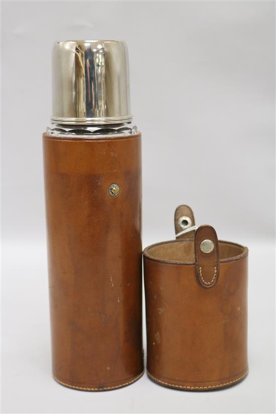A silver plated flask in leather case